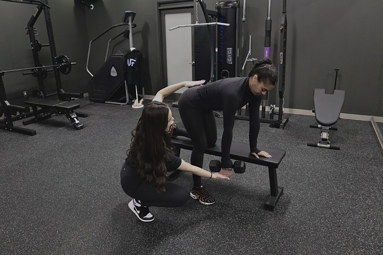 Meredith Parry coaching a client through a single-arm dumbbell row.