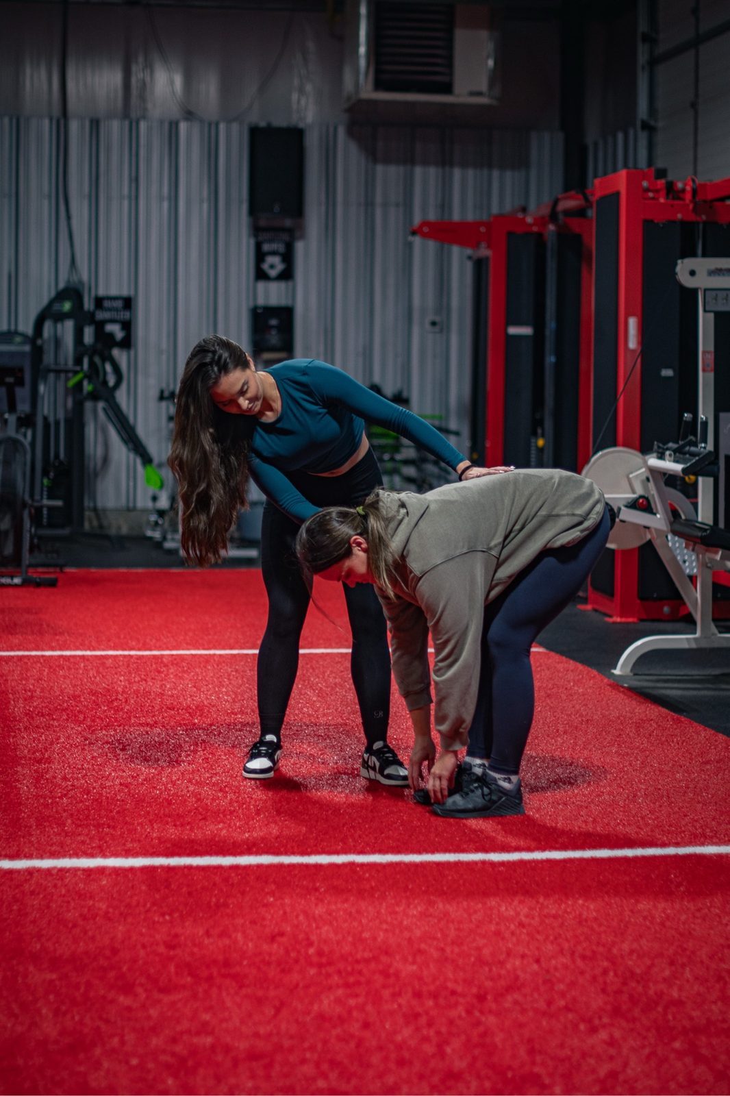 Meredith Parry coaching a client one-on-one in the gym.