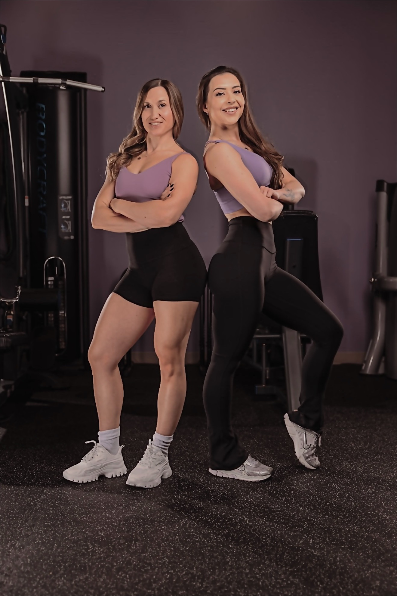 Coaches Nicole Vanderhorn and Meredith Parry, back to back in the studio.